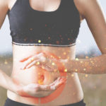 woman with hands over gut area