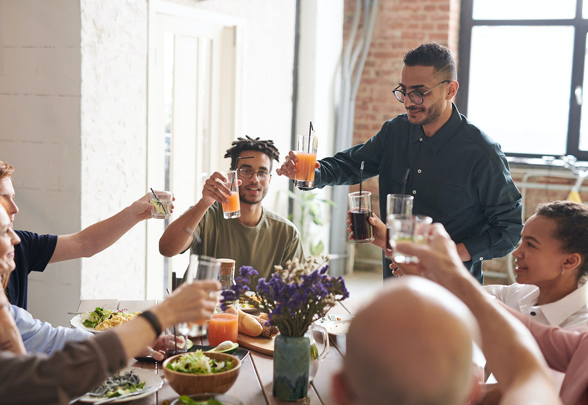 man at a table enjoying a healthy meal with friends