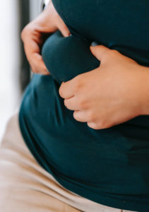 woman pinching fat under her chest area