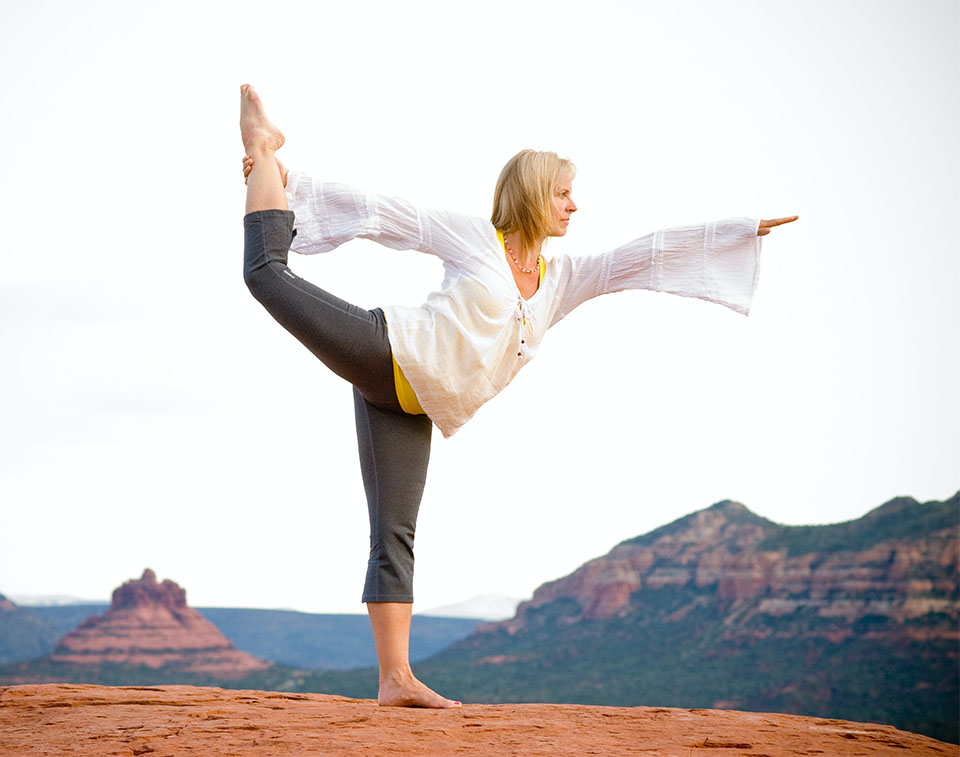 woman in a yoga pose in front of a mountain