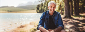 Happy man at water's edge.