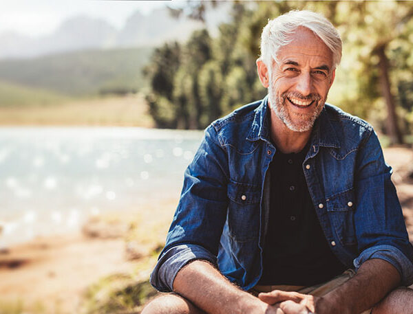 Happy man at water's edge.