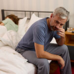 Man with ED on side of bed.