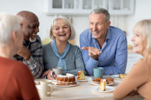 Happy older people around a table