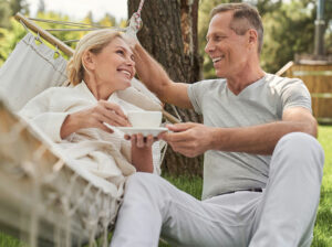 happy older couple in hammock