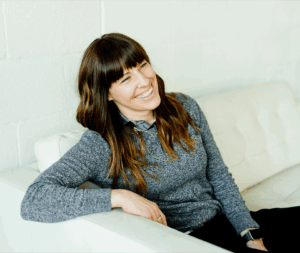 Confident woman sitting on couch